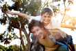 © Arnell K/peopleimages.com - Father, boy child and outdoor for piggy back with arms and smile, vacation in Australia with portrait. Male person, son and happy for game or playful in nature, support in summer and fun in England