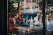 © qunica.com - Two business professionals engaged in a meeting at a contemporary cafe setting, discussing project plans and strategies.
