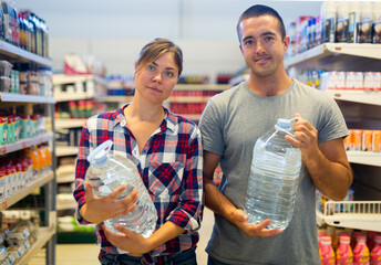 Wall Mural - Husband and wife buy drinking water in a grocery supermarket