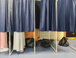 © o1559kip - Voters in booths and trash bags for throwing away ballots