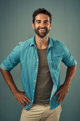 Poster - Confident. denim and fashion with portrait of man in studio on gray background for relaxed clothing style. Casual, happy and smile with natural person in clothes outfit to model jacket or wardrobe