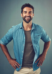 Poster - Denim, fashion and smile with portrait of man in studio on gray background for relaxed clothing style. Casual, confident and happy with natural person in clothes outfit to model jacket or wardrobe