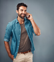 Poster - Happy man, fashion and style in phone call with trendy, cheerful in studio on gray background. Male person, smile and outfit for confidence, retail or sale in communication for promo in denim shirt