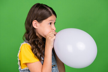 Poster - Photo of kid girl look profile side blow balloon isolated green color background