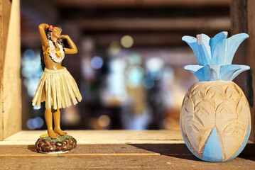 Hawaiian Hula Doll and Wooden Pineapple on Shelf.