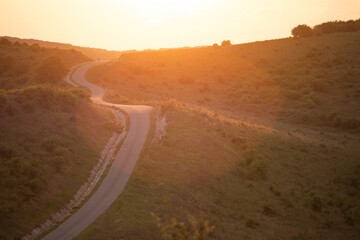 Wall Mural - Long winding road in rural countryside leading off into distance.