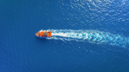 Wall Mural - vacation and leisure. aerial view on fast boat on blue sea at sunny day. fast ship on the sea surfac