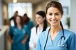 © Xyeppup - Close-up of a smiling female doctor, soft focus on busy staff in background