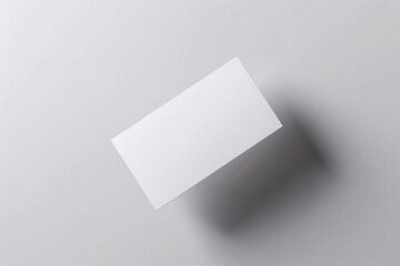 professional business card mockup floating above a white paper background, clean and elegant style