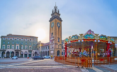 Canvas Print - Carousel against Memorial Tower in Bergamo, Italy