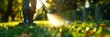 © Olena - Worker spraying pesticide onto green lawn outdoors, closeup. Pest control