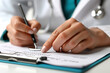 © Pixten - Doctor with stethoscope in clinic, writing a prescription close-up