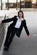© Павел Костенко - Attractive caucasian young woman in suit posing while walking outdoors on spring day. Luxurious, sexy and elegant lady looking at the camera. Beauty, Fashion, Style, Lifestyle.
