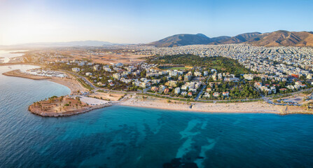 Wall Mural - Aerial view of the coastline of Glyfada, south Athens, Greece, with beaches and marinas during summer sunset time