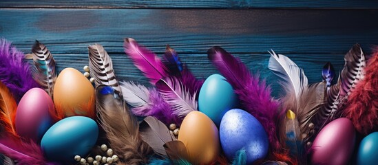 Aufkleber - Colorful feathers provide a vibrant backdrop for decorative Easter eggs The image offers plenty of copy space creating a flat lay composition