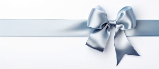 Aufkleber - A silver shiny satin ribbon bow with ribbon is positioned by the corner of a frame creating an isolated copy space image on a white background suitable for a holiday theme