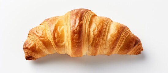 Poster - Close up top view of a traditional French pastry an appealing plain mini croissant baked to a golden crisp The studio shot shows the croissant in isolation on a white background with ample copy space