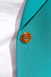 © Westend61 - Button on turquoise colored blazer with white t-shirt