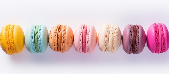 Aufkleber - Top view of colorful almond cookies resembling biscuits macaron or macaroon placed on a white background A diary is present providing space to write down a recipe. Creative banner. Copyspace image