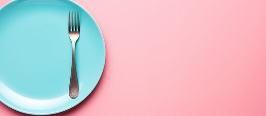 Aufkleber - Top view of a clean blue ceramic plate accompanied by a stainless knife and fork isolated on a pink background The cutlery is neatly organized ready for a delicious meal Copy space is available for y