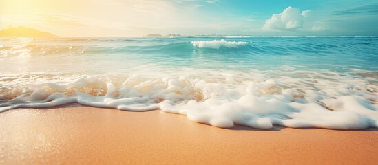 Poster - There is a blurred tropical beach with bokeh sunlight and wave abstract background creating a vintage tone filter effect for a copy space image representing an outdoor summer vacation and travel adve