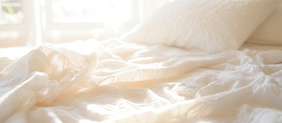Poster - A close up photo of a white patterned blanket on a bed captured with the morning sun streaming in through a window showcasing a beautiful copy space image
