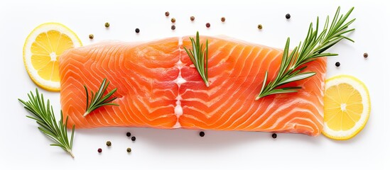 Poster - A top down view of a raw piece of salmon accompanied by lemon slices and rosemary sprigs isolated on a white background Ample space available for additional text or images