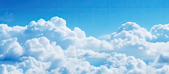 Poster - Copy space image of a serene blue sky adorned with exquisite white clouds boasting a captivating color transition from vibrant blue to a gentle fade forming a picturesque cloudscape