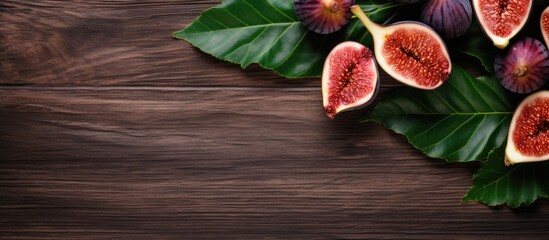 Poster - An arrangement of whole and sliced ripe figs complete with their leaves displayed on a wooden table This flat lay composition provides ample copy space for text