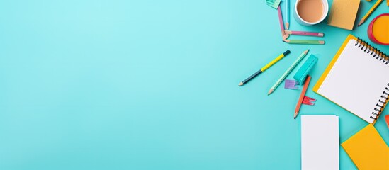 Poster - Colorful office supplies and stationery items are displayed on a turquoise background creating a back to school vibe The light colored backdrop features empty sticky notes providing ample copy space