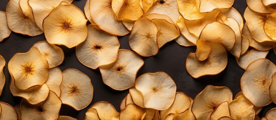 Aufkleber - A top view of organic dried apple chips arranged on a gray textile background creating an image that showcases the natural and healthy aspect of the food Flat lay presentation with ample copy space