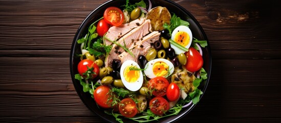 Aufkleber - A top down view of a French cuisine Salad Nicoise showcasing a vibrant and nutritious mix of tuna green beans tomatoes eggs potatoes and black olives in a bowl on a table Ample copy space image