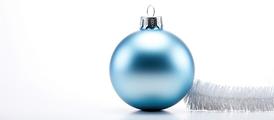 Sticker - A silver and blue Christmas ornament placed on a white background providing ample space for additional text or images The ornament is arranged in a flat lay style