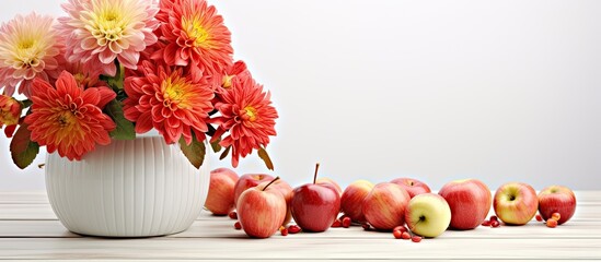 Wall Mural - Indoor shot featuring exquisite chrysanthemum flowers in a pot and ripe apples neatly arranged on a white wooden table leaving room for textual additions. Creative banner. Copyspace image