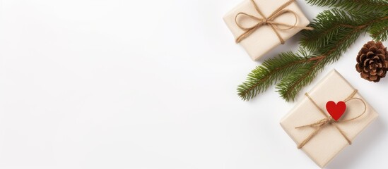 Poster - Top view of a Christmas themed flat lay with the word Love and a small gift box surrounded by spruce branches This isolated image on a white background can be used as a holiday concept mock up or a b