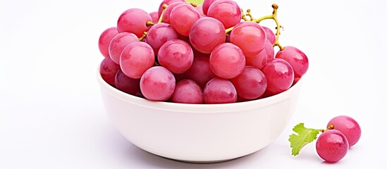 Poster - The image shows a top view of a bowl filled with pink grapes Kishmish The grapes are isolated on a white background and there is copy space available for text The set captures the grapes from various