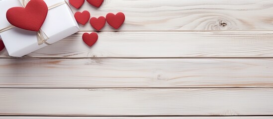 Poster - Top view of a gift box and hearts set against a backdrop of white painted wooden planks The image provides ample space for accompanying text