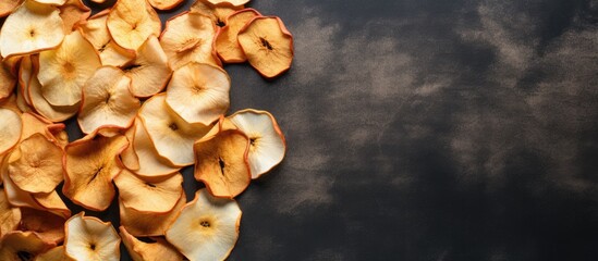Aufkleber - A top view of organic dried apple chips arranged on a gray textile background creating an image that showcases the natural and healthy aspect of the food Flat lay presentation with ample copy space