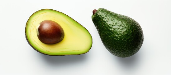 Aufkleber - An avocado sliced in half rests on a white backdrop The image offers copy space and serves as a banner that complements eco friendly cosmetics