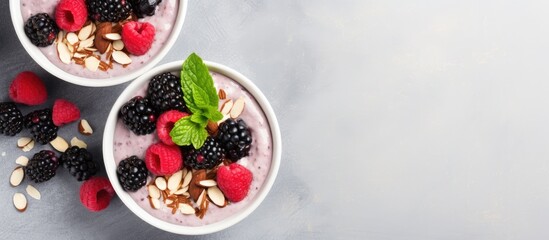 Aufkleber - A healthy dessert of mashed berries banana and natural yogurt in a white bowl Adorned with frozen blackcurrant sliced almonds and black sesame seeds Top view with ample copy space