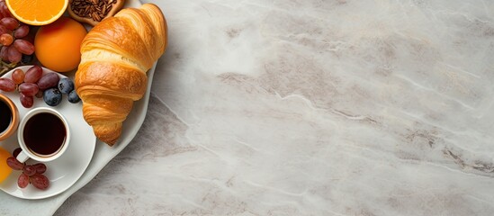 Poster - Top down view of a stone table adorned with breakfast essentials like coffee orange juice and a croissant The composition offers copy space for added creativity in the image