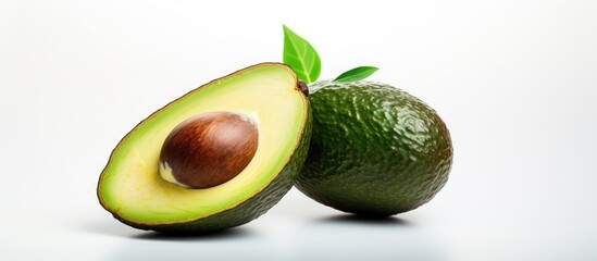 Aufkleber - An avocado sliced in half rests on a white backdrop The image offers copy space and serves as a banner that complements eco friendly cosmetics