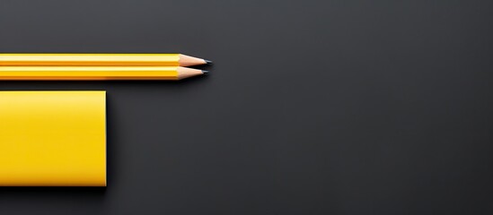 Aufkleber - A yellow pencil and black pen lie on a gray background providing space for text The top down perspective known as the flat lay style showcases these school office supplies. Creative banner