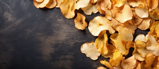 Aufkleber - A top view of organic dried apple chips arranged on a gray textile background creating an image that showcases the natural and healthy aspect of the food Flat lay presentation with ample copy space