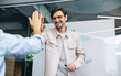 © Jacob Lund - Business man high fiving his colleague in celebration of their success as a team