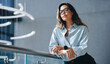 © Jacob Lund - Confident business woman standing on a balcony in a business convention center
