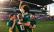 © Jacob Lund - Football players celebrating victory in a professional football match at a full big stadium