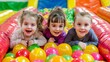© Дмитрий Симаков - Three children are playing in a ball pit, smiling and laughing