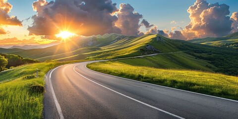 empty highway in the beautiful mountains, sky illuminated by the sun's rays at sunset, incredible na