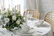 © Prasanth - Beautiful table setting with eustoma flowers and candles for wedding celebration in room